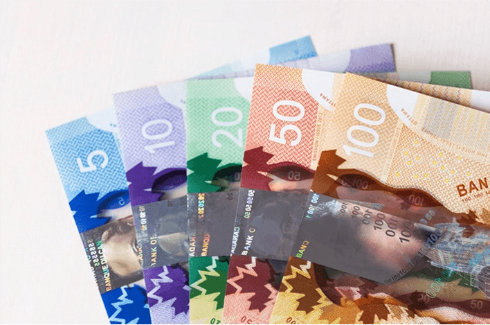 Canadian bank notes of various denominations arranged sequentially